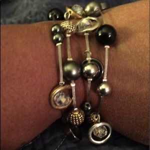Silver tone bracelet w/ beads and crystals etc.